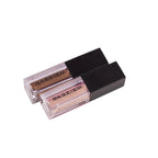 Two small rectangular containers of liquid eyeshadow with applicators, one with cap off showing the product.